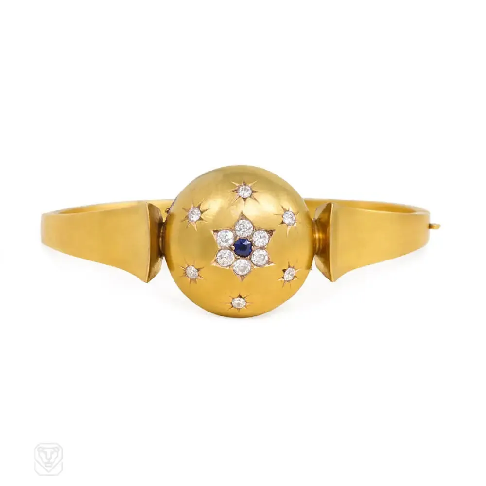 Antique gold bangle with central diamond and sapphire flower