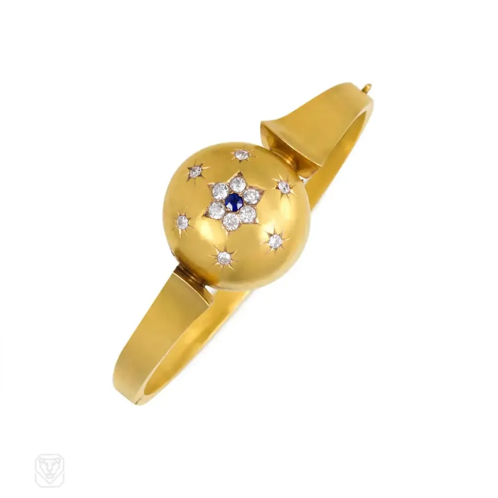 Antique gold bangle with central diamond and sapphire flower