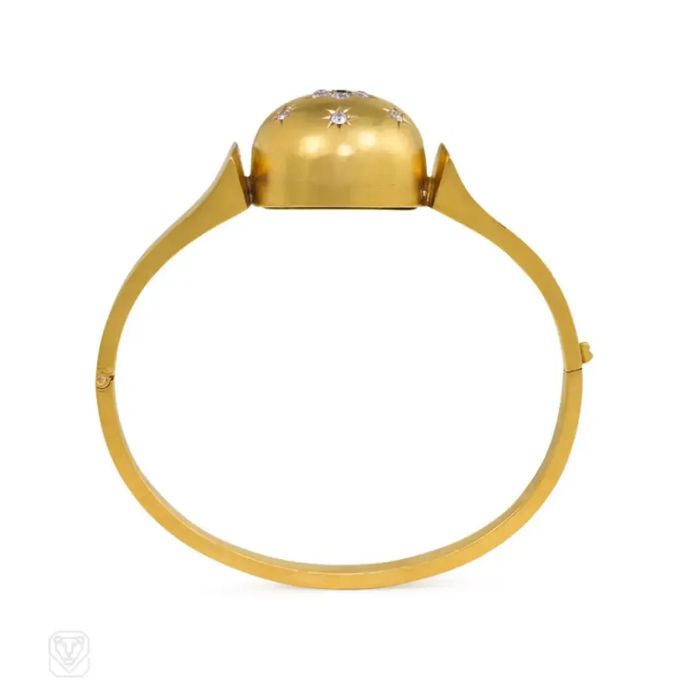 Antique gold bangle with central diamond and sapphire flower