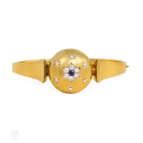 Antique gold bangle with central diamond and sapphire flower