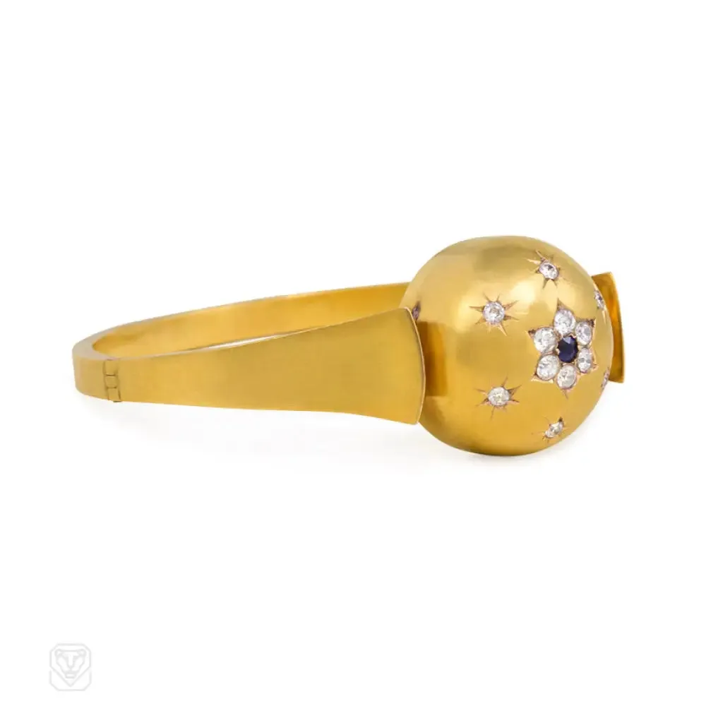 Antique gold bangle with central diamond and sapphire flower